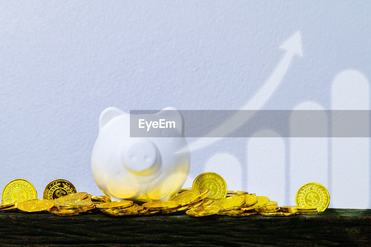 CLOSE-UP OF COINS ON WHITE TABLE