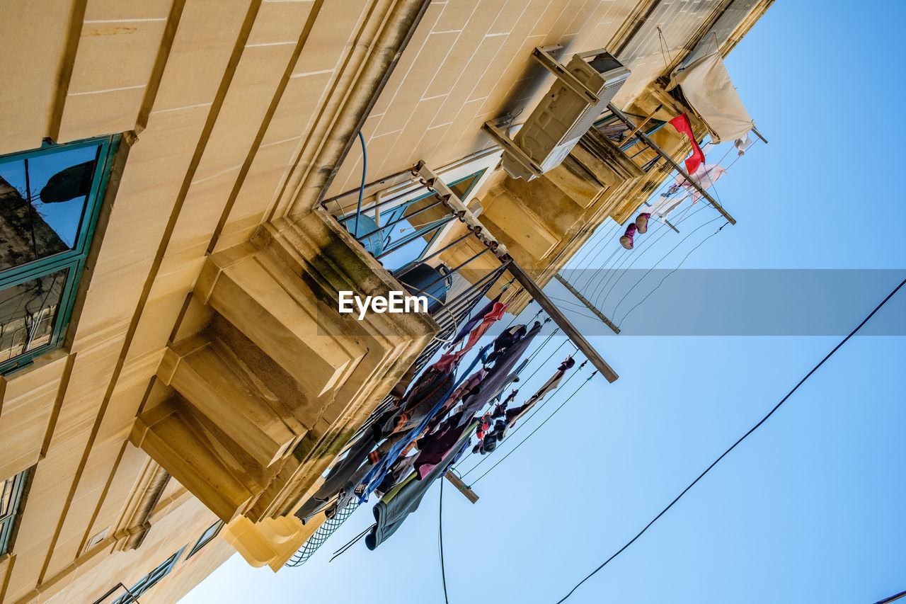 low angle view, architecture, sky, built structure, nature, day, occupation, mast, cable, industry, blue, building exterior, working, outdoors, construction industry, clear sky, no people, technology, construction site