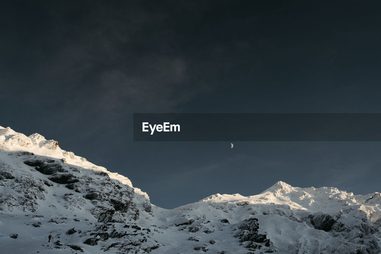 scenic view of snowcapped mountains against blue sky