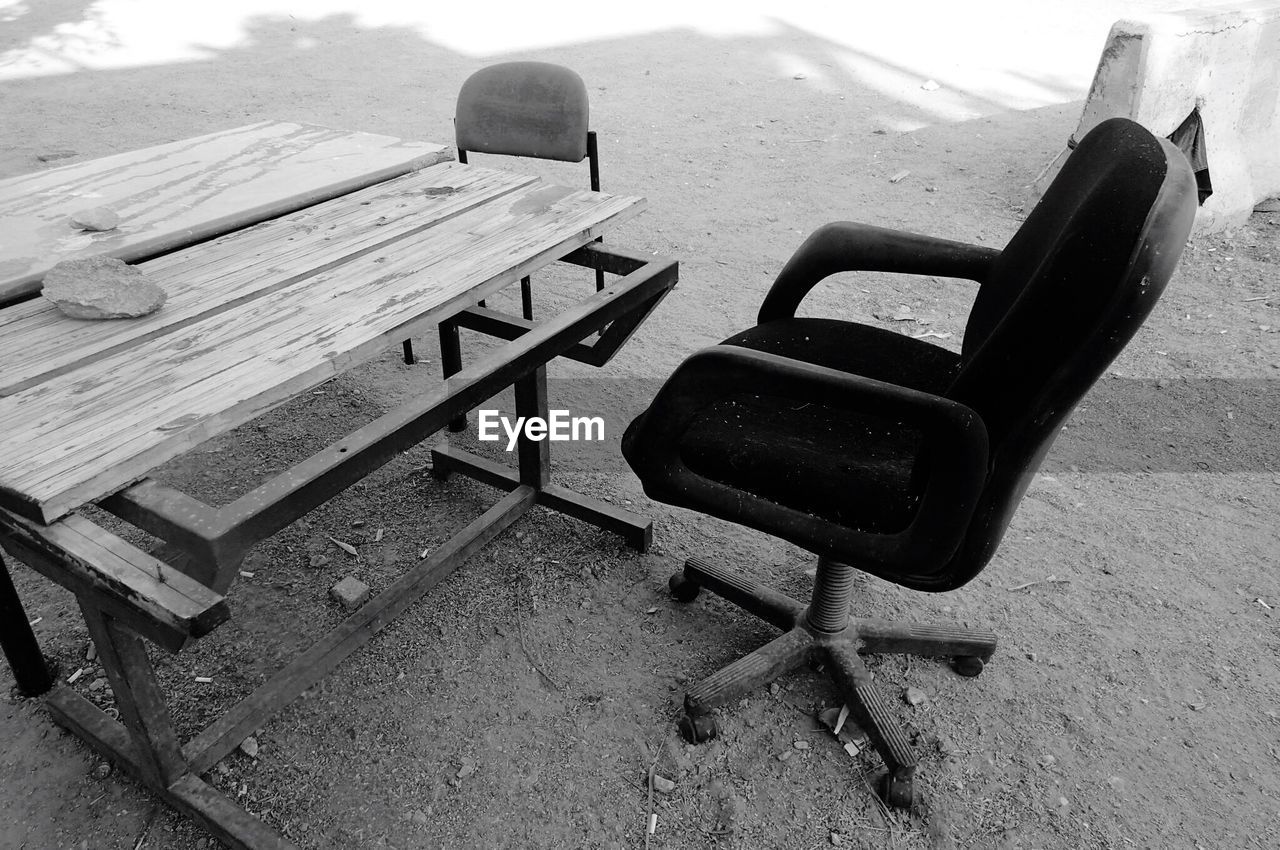 CHAIRS AND TABLE ON SAND