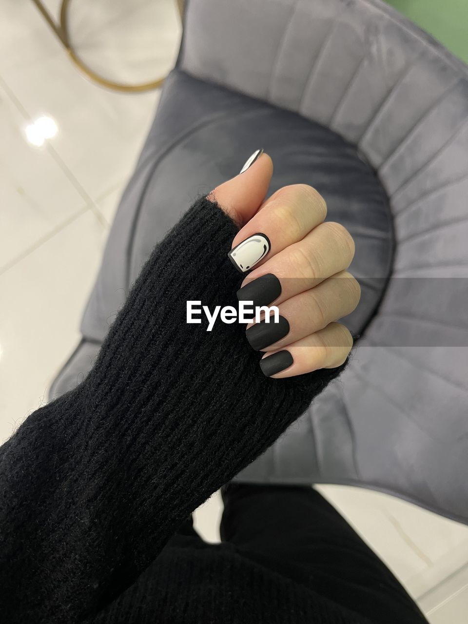 black, finger, arm, human leg, glove, one person, limb, hand, adult, indoors, lifestyles, close-up, clothing, safety glove, women, footwear