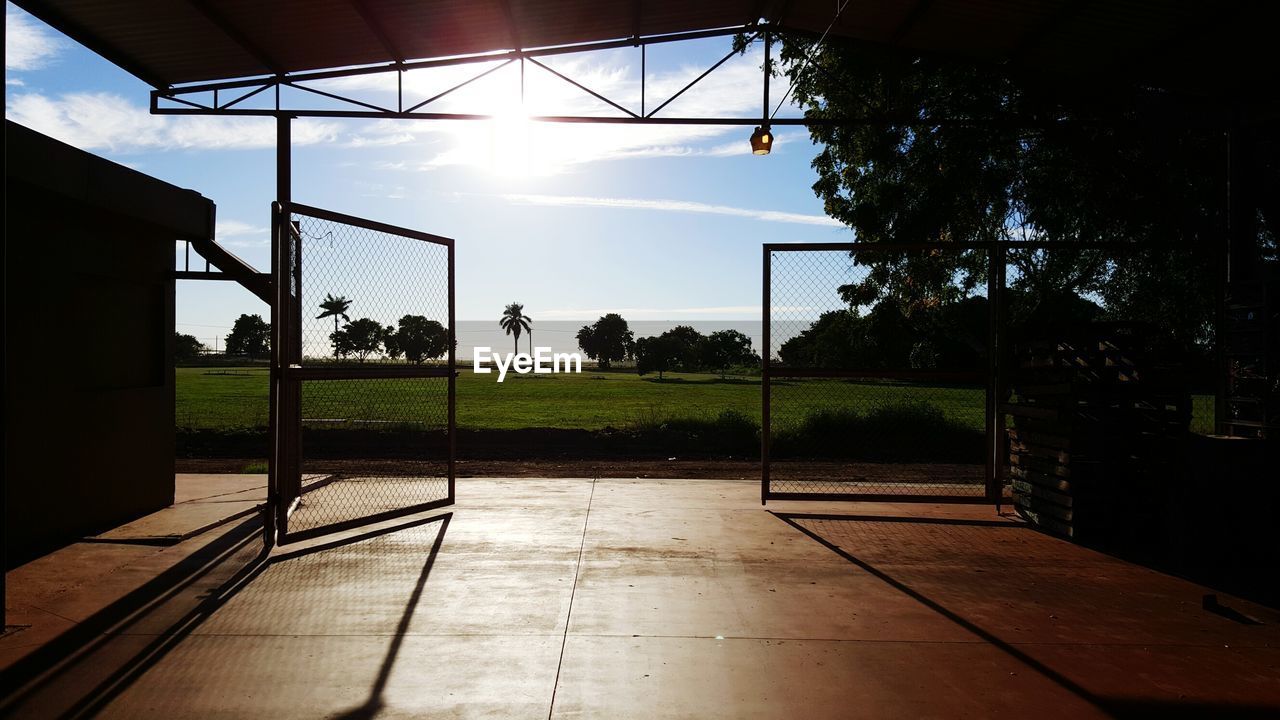 VIEW OF BASKETBALL HOOP ON FIELD AGAINST SKY