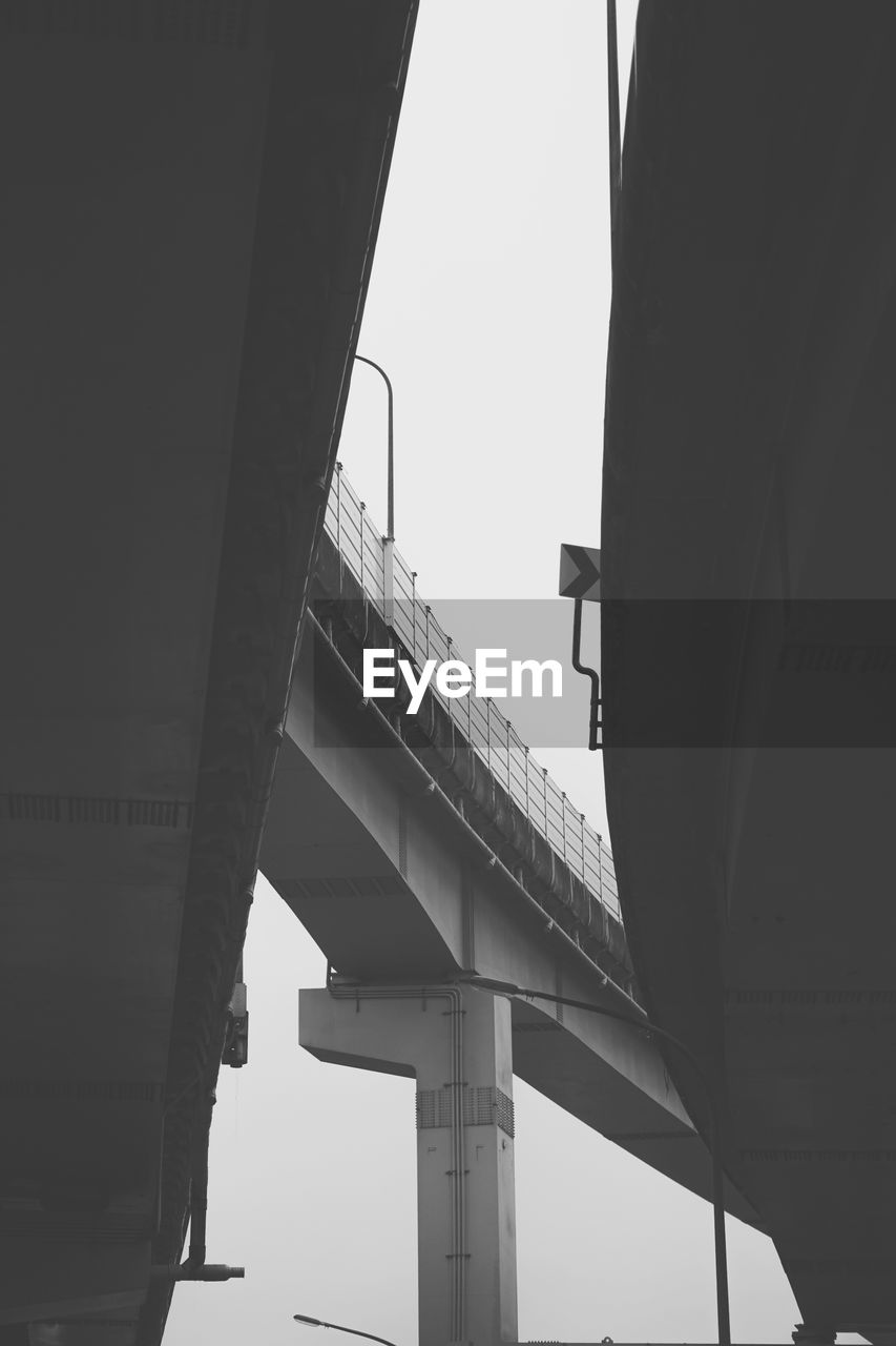 LOW ANGLE VIEW OF ELEVATED ROAD AGAINST SKY