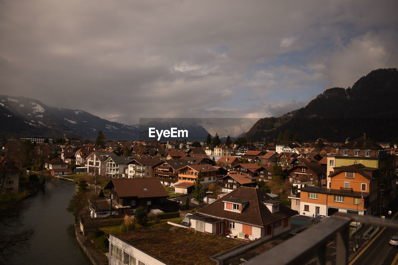 High angle view of townscape and mountains against sky