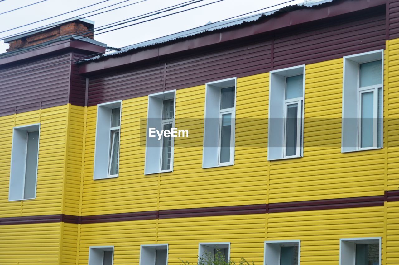 Low angle view of multi colored building against clear sky