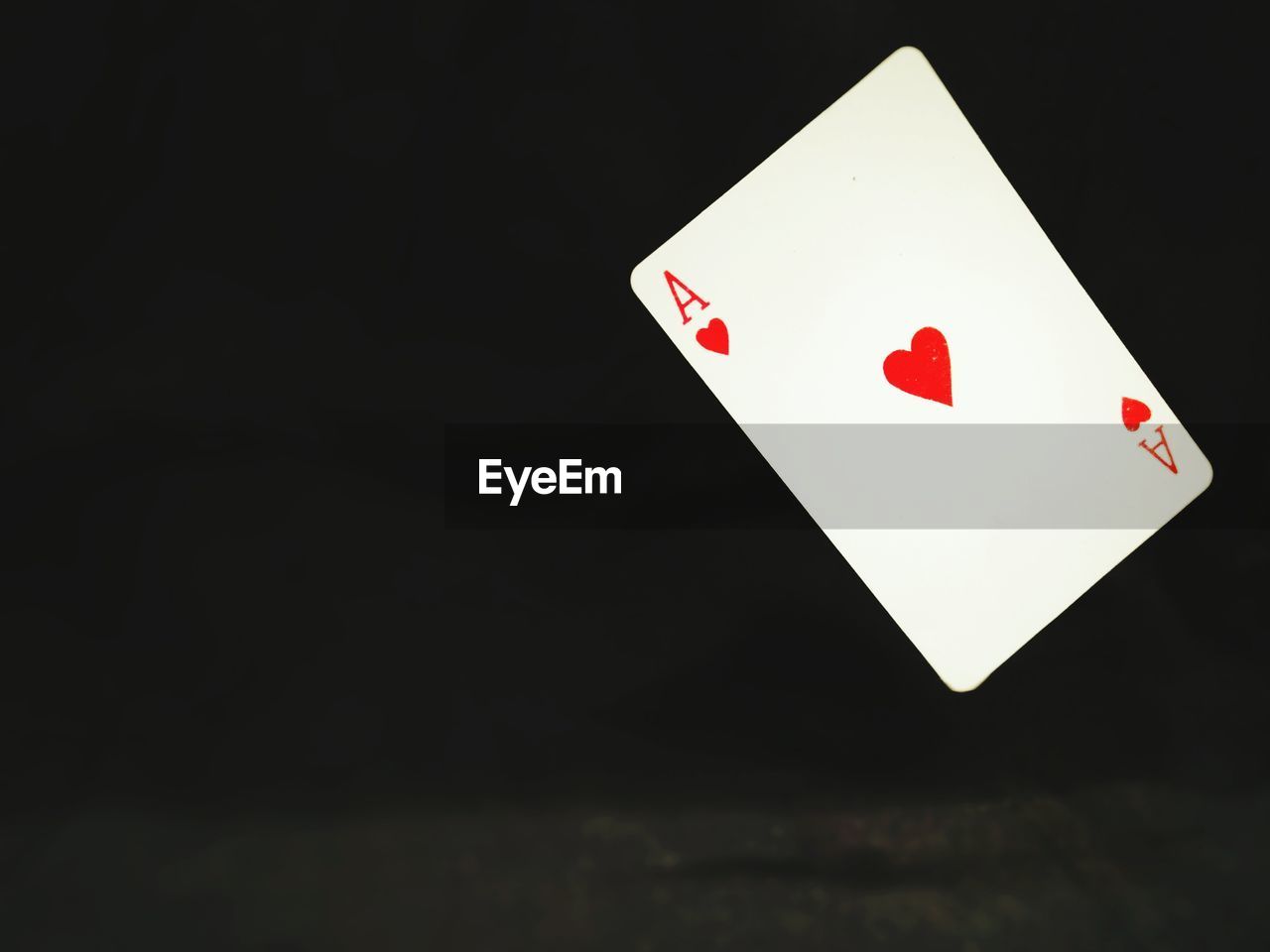 Close-up of ace of hearts against black background