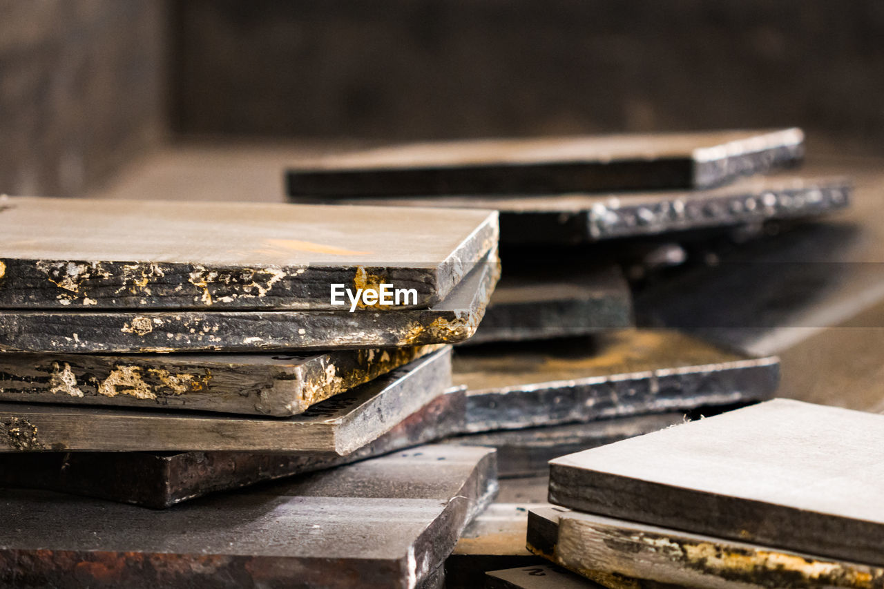 CLOSE-UP OF OLD STACK ON TABLE AT HOME