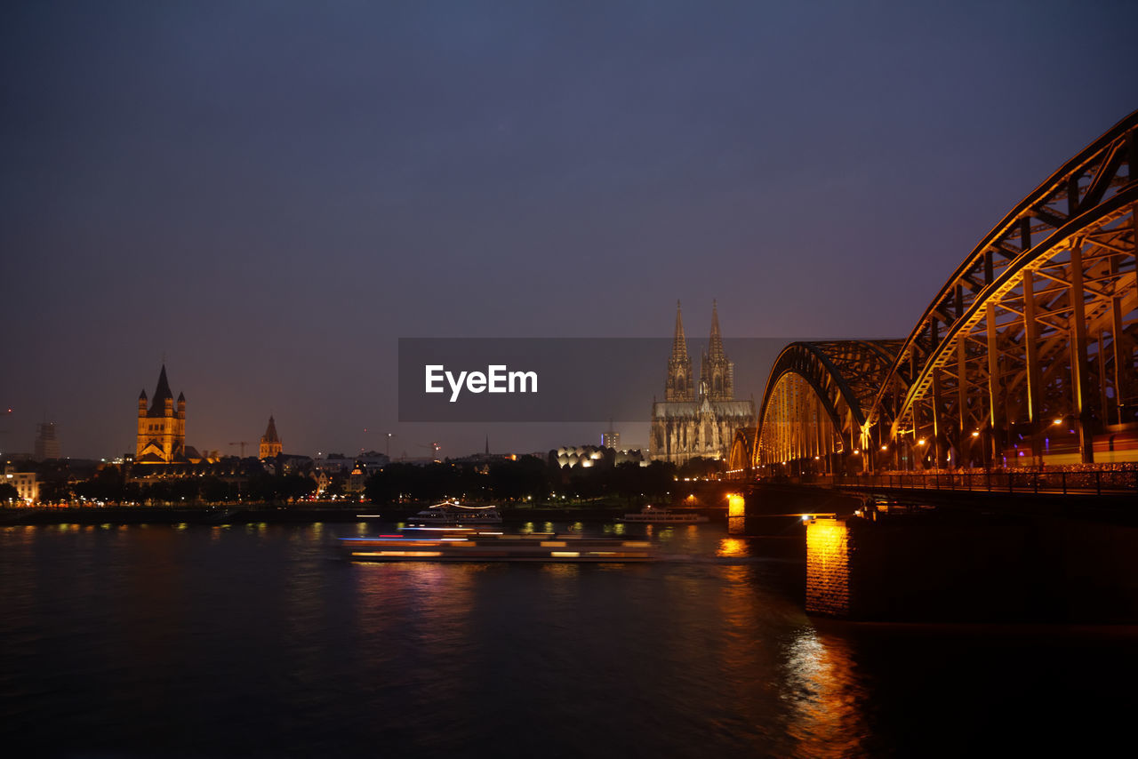 Cologne cathedral and bridge in front of sea sky at dusk