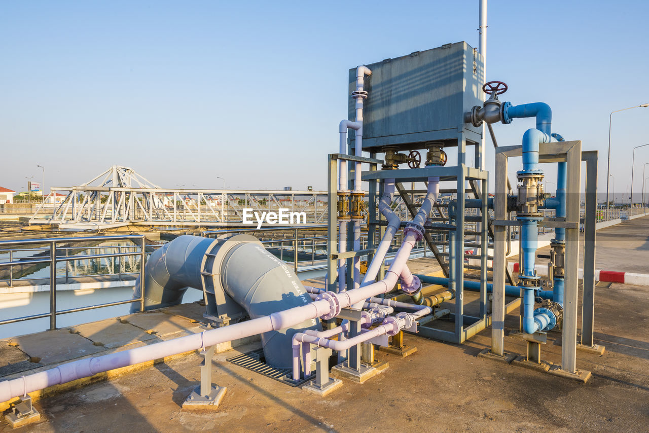 Close-up of water treatment plant against sky