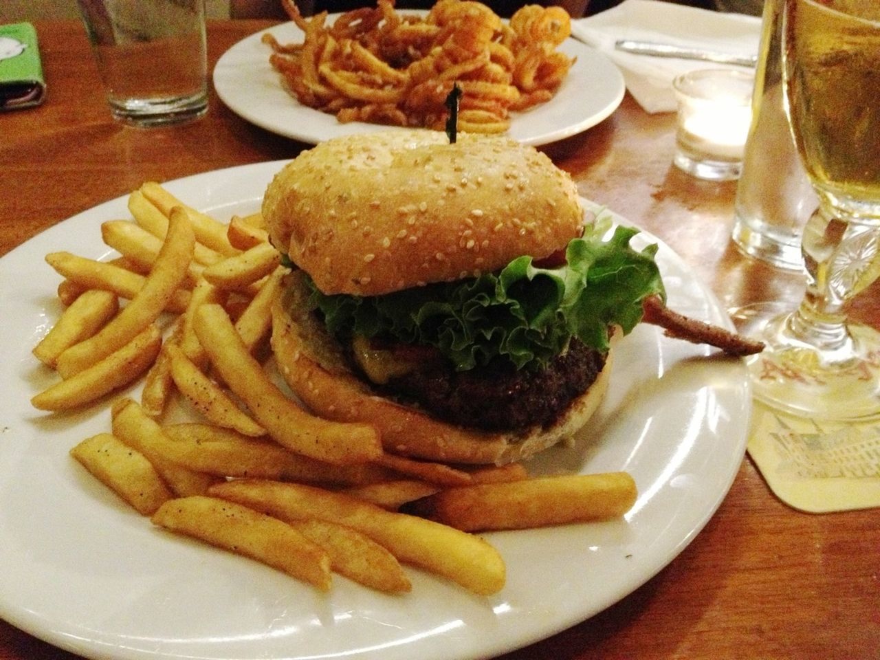 Close-up of fries with burger on table