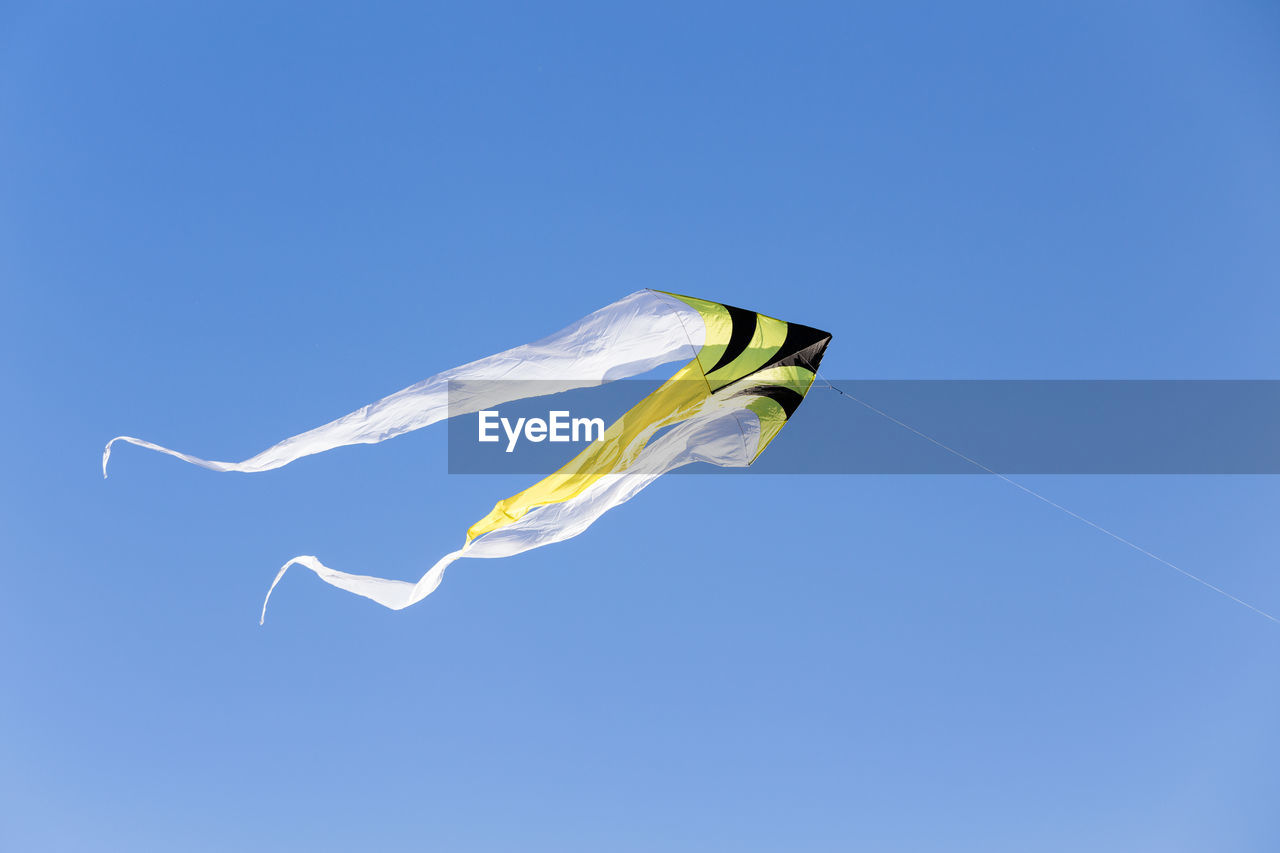 LOW ANGLE VIEW OF KITE FLYING IN SKY