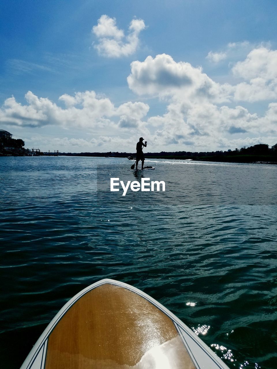 MAN ON BOAT AGAINST SKY