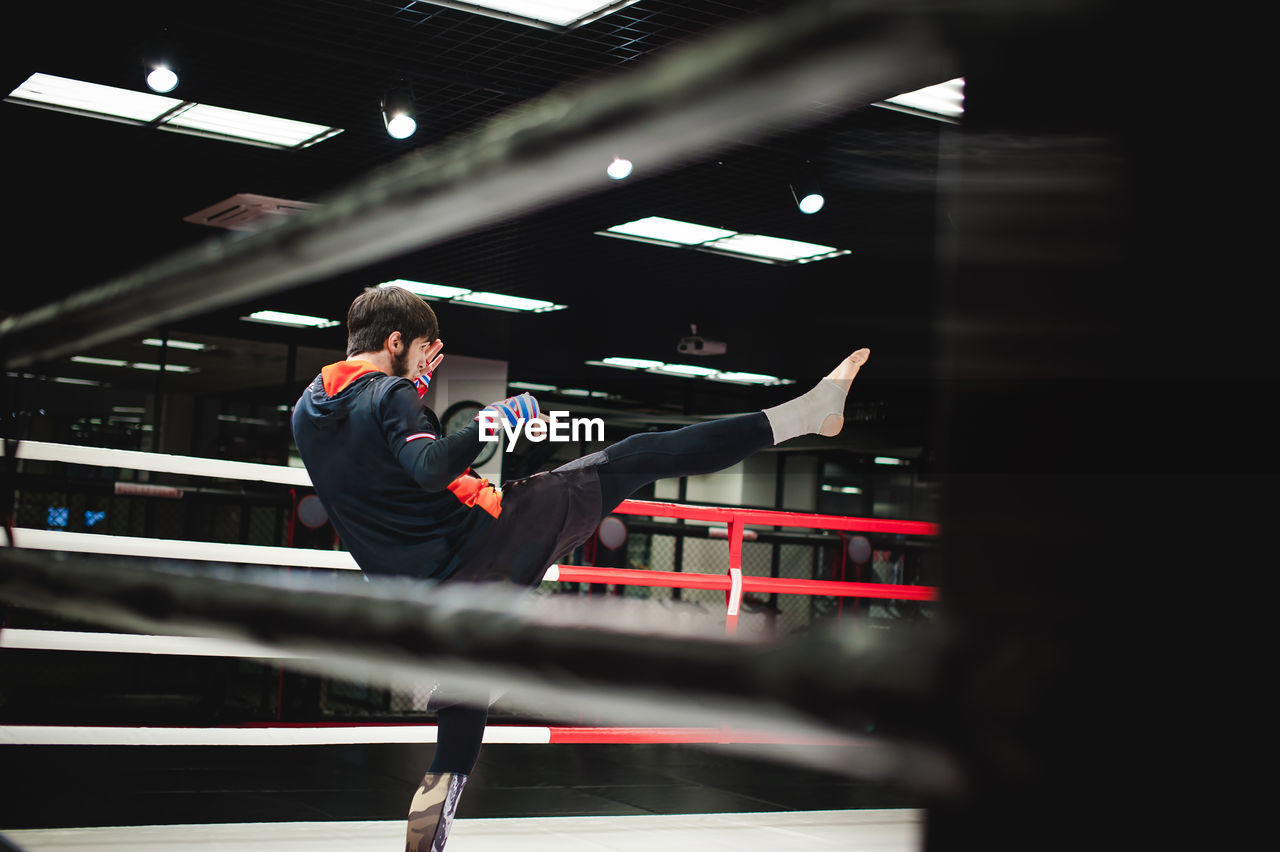 Man practicing boxing in ring