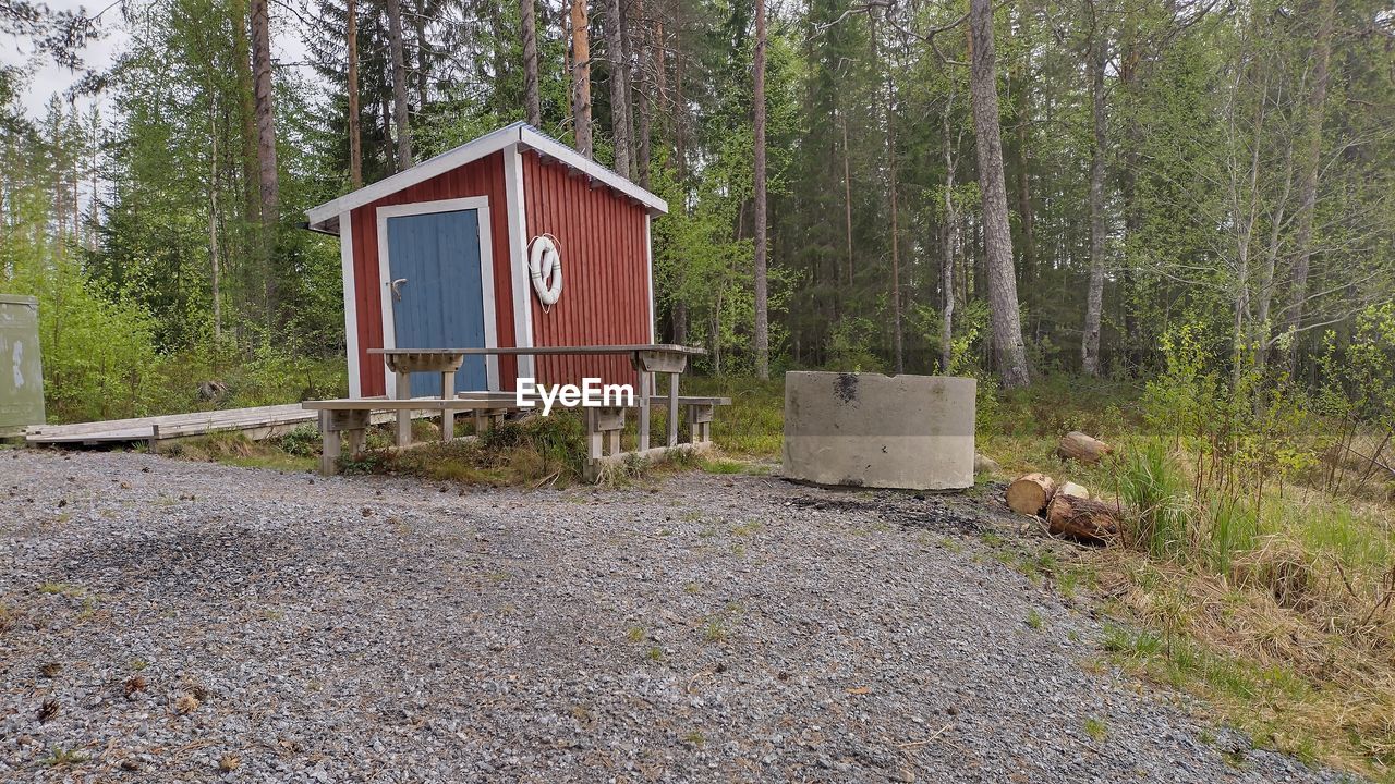 tree, plant, built structure, architecture, no people, nature, land, building exterior, day, forest, cottage, building, home, house, growth, shack, outdoors, hut, wood, non-urban scene, tranquility, backyard, shed, yard, landscape, trail