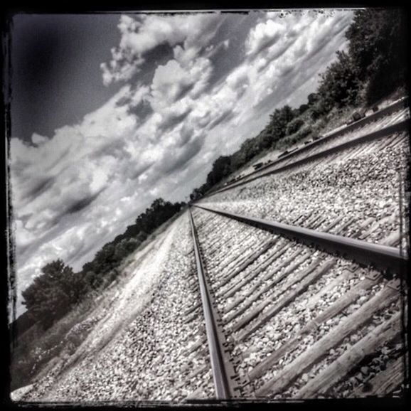 RAILROAD TRACKS ON CLOUDY DAY