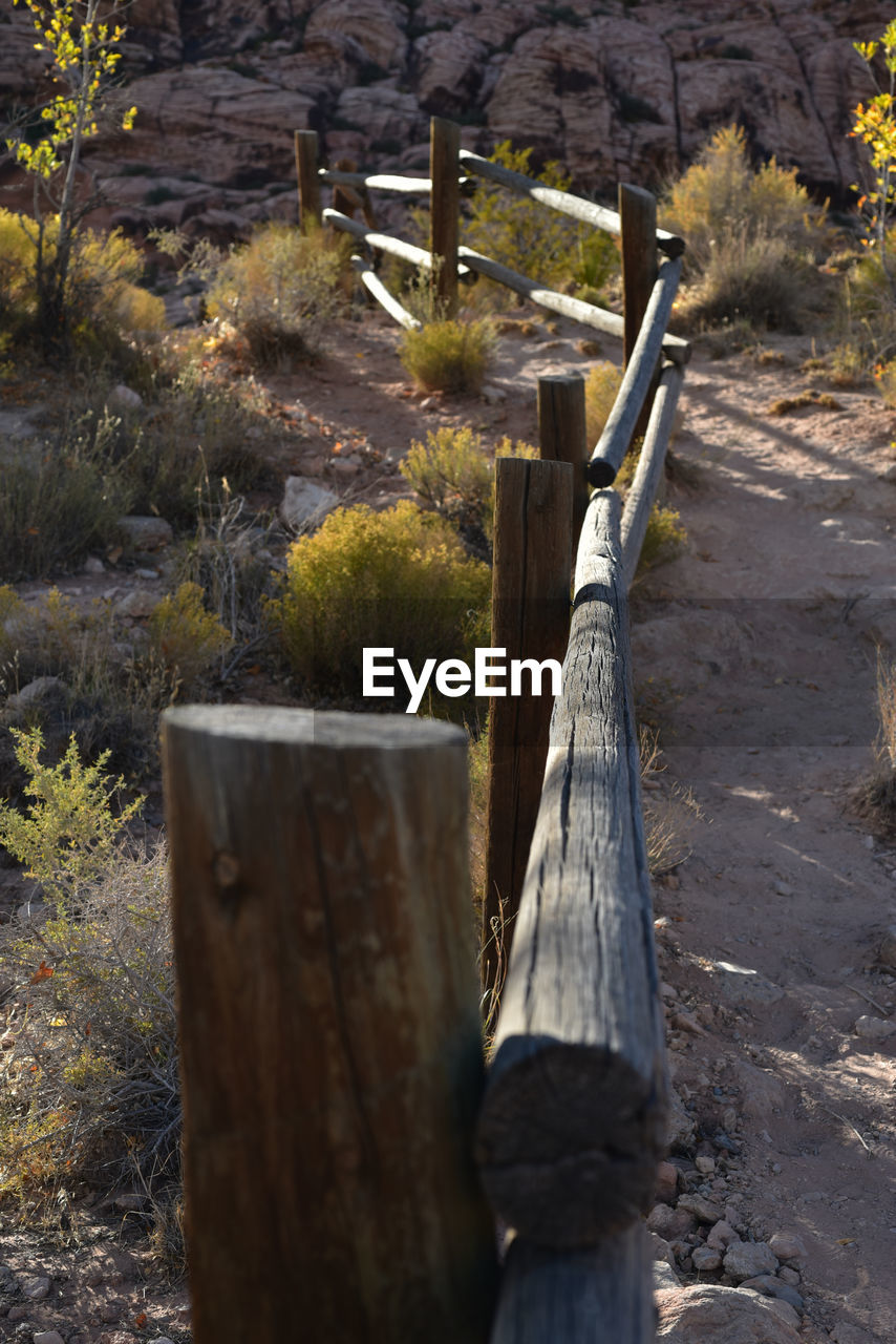 WOODEN POST ON FIELD