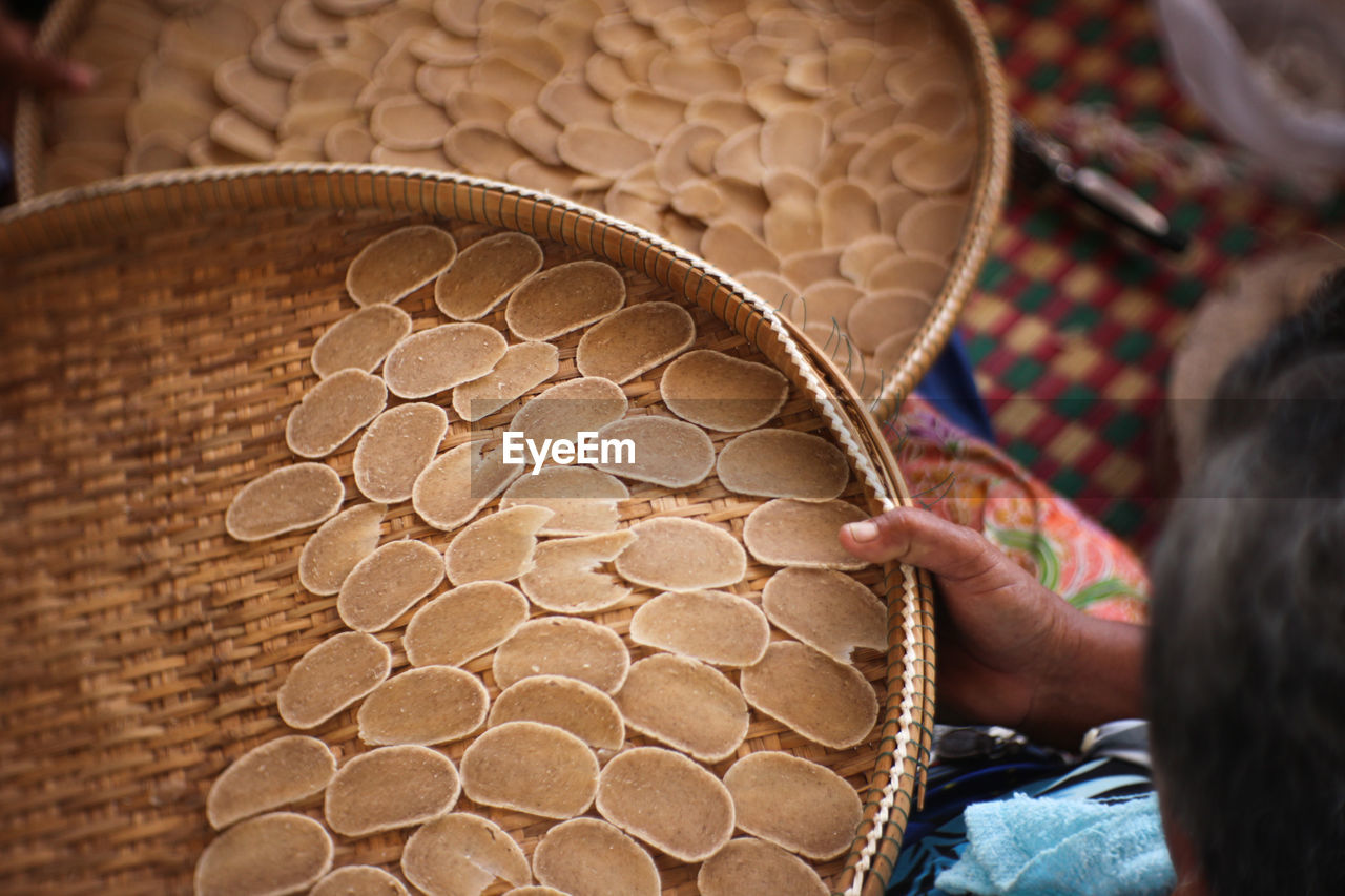 High angle view of woman holding wicker basket