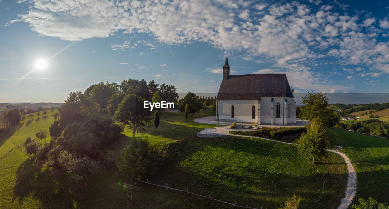 View of church and trees against sky