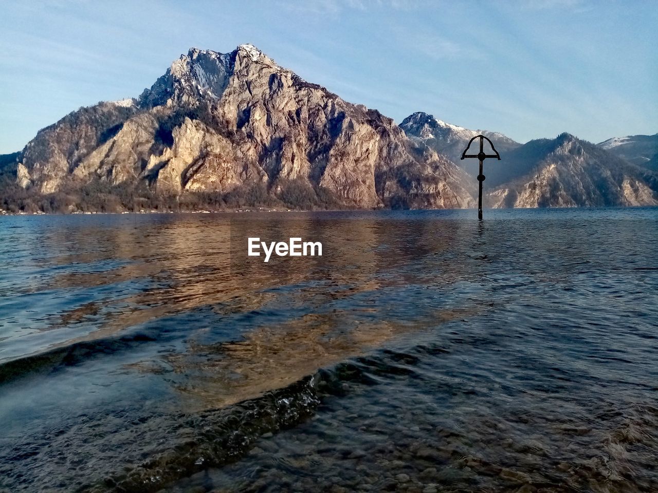 Scenic view of sea and mountains against sky