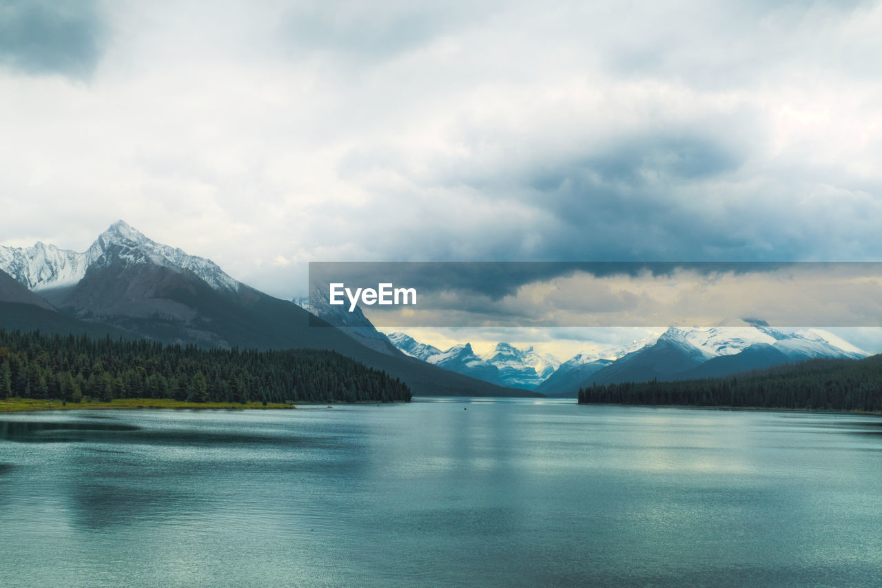 Scenic view of lake and snowcapped mountains against sky