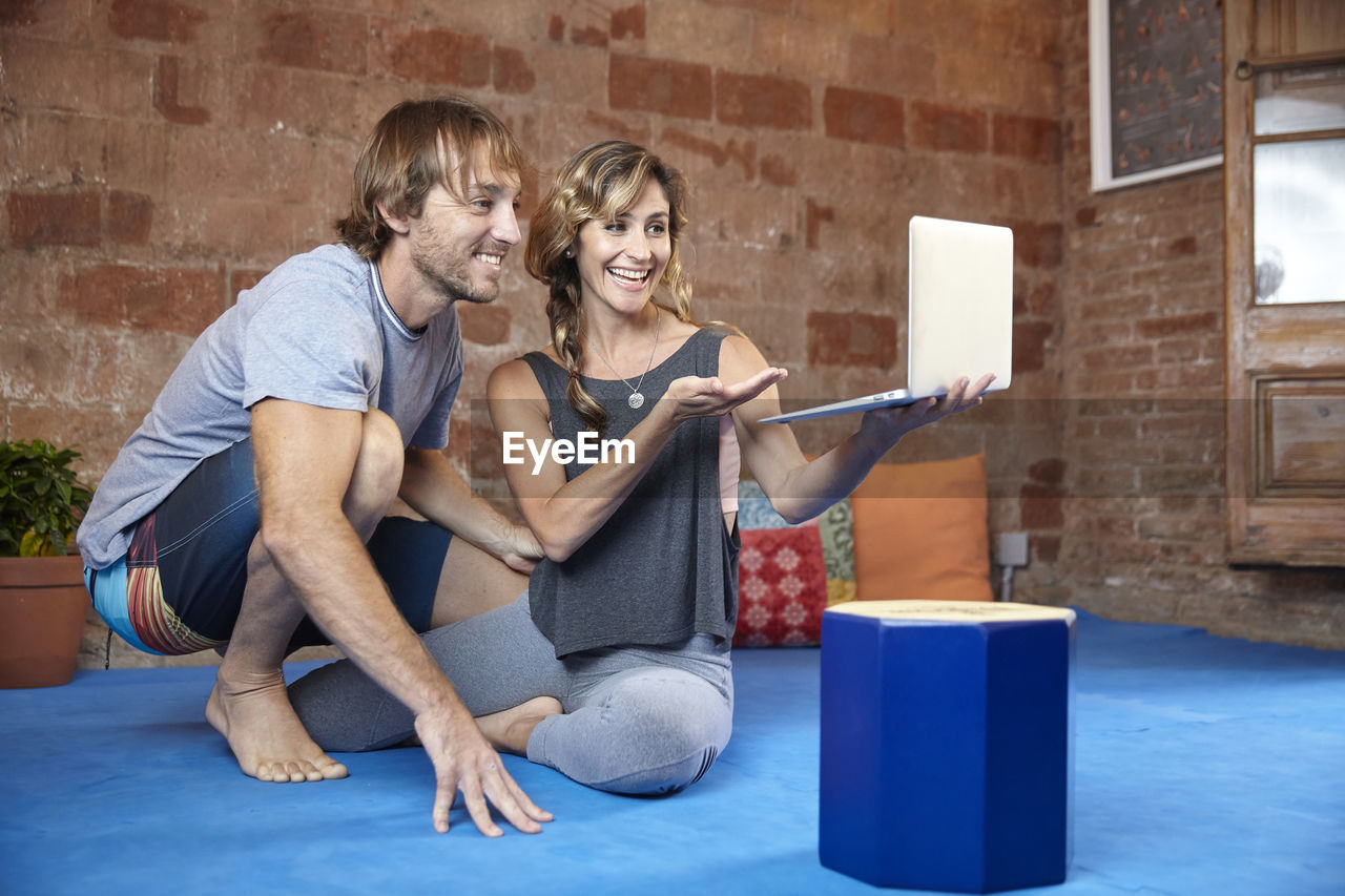 Couple doing yoga classes online