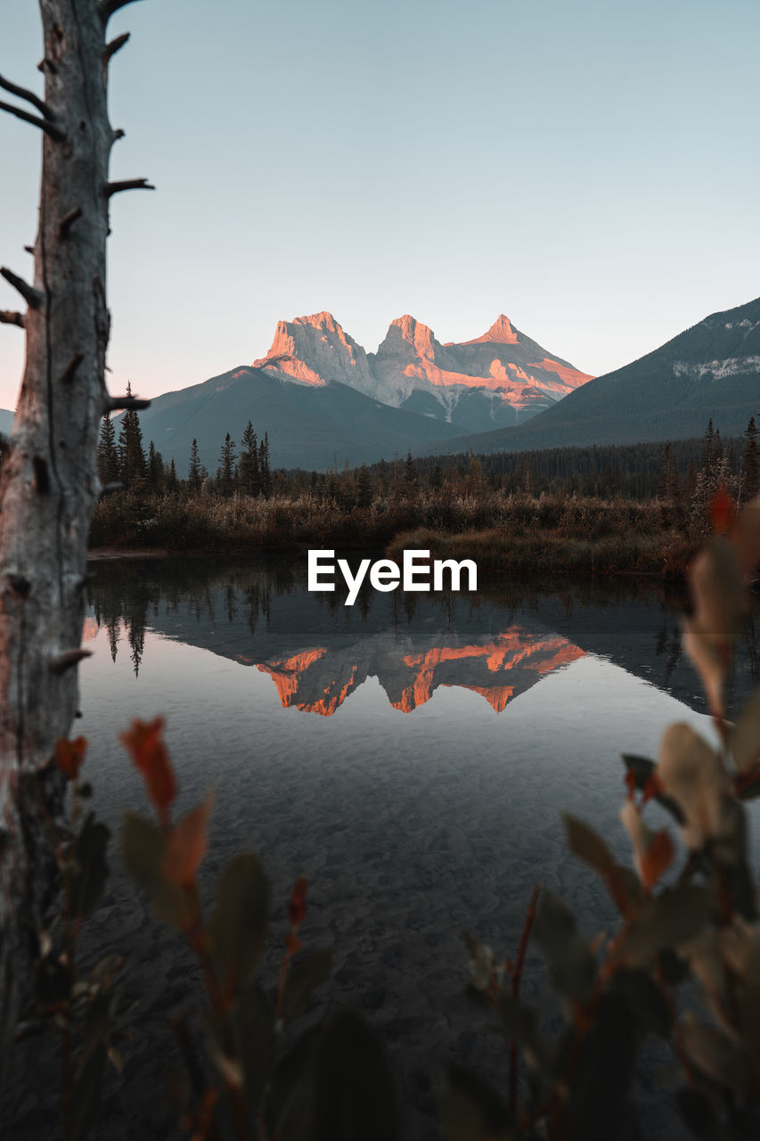 Scenic view of lake and mountains against sky in canmore, alberta, canada