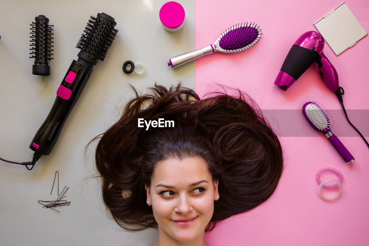 Woman with brown hair by personal accessories on table