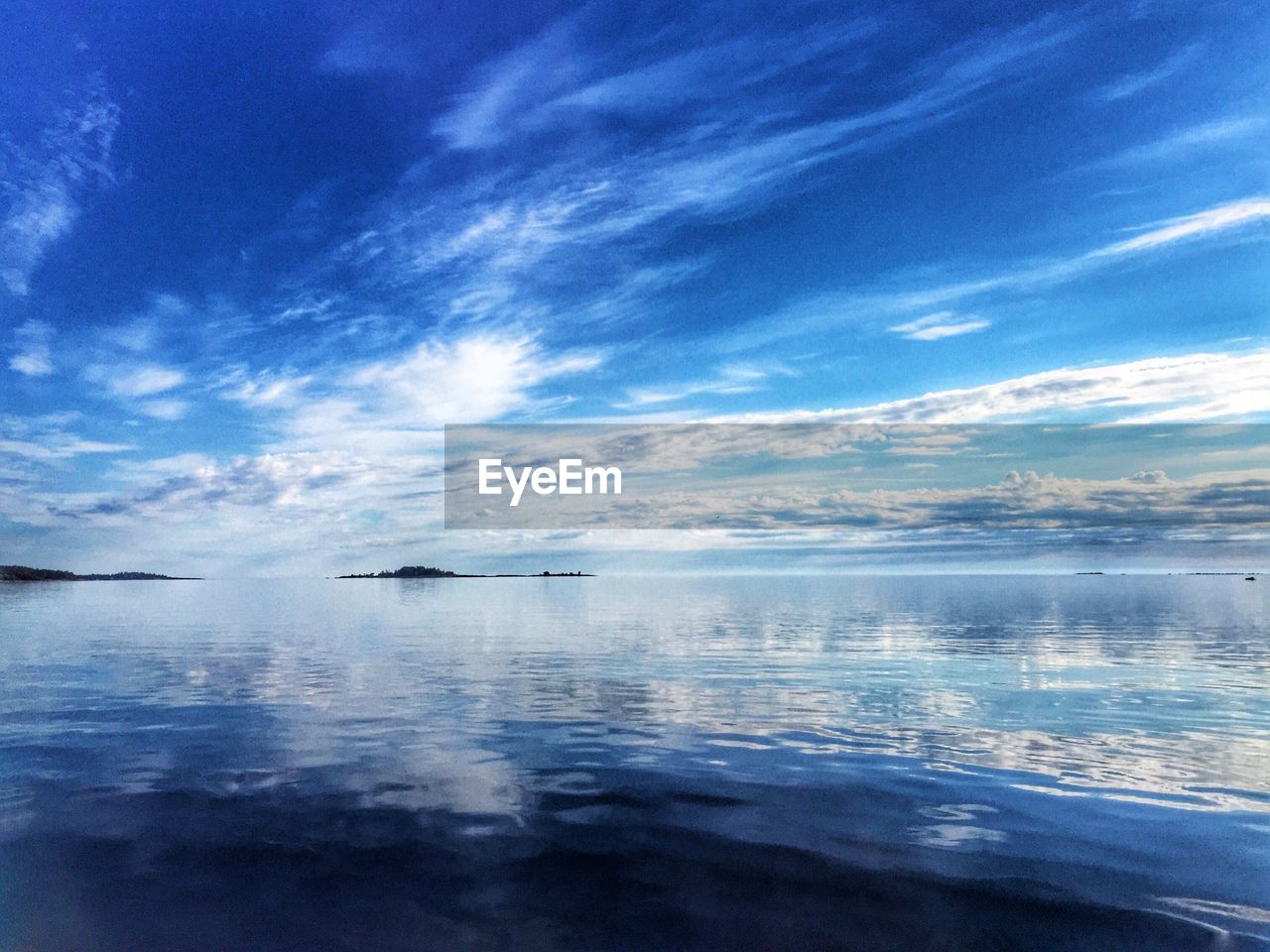 Scenic view of sea against blue sky