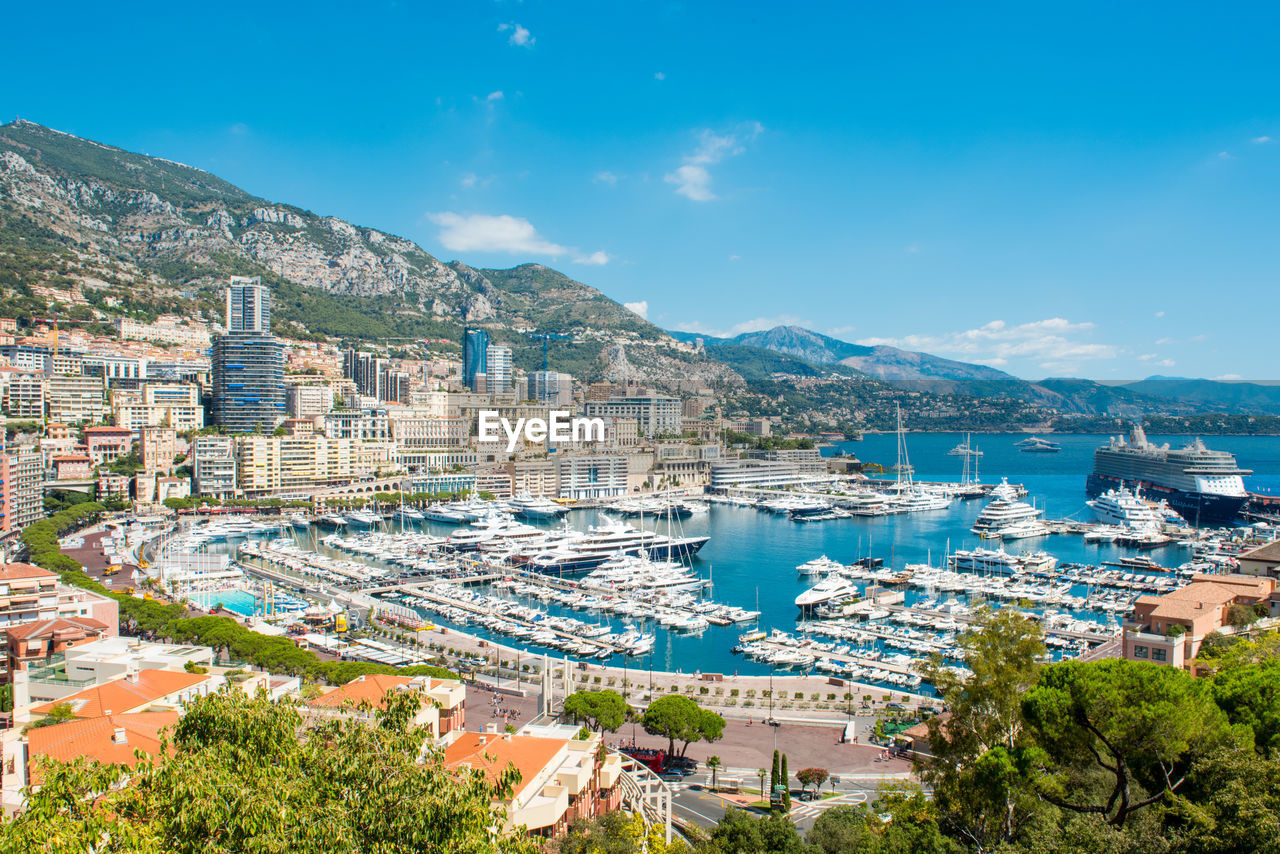 High angle view of cityscape by sea against sky