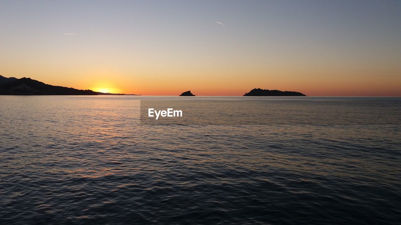 Scenic view of sea against sky during sunset