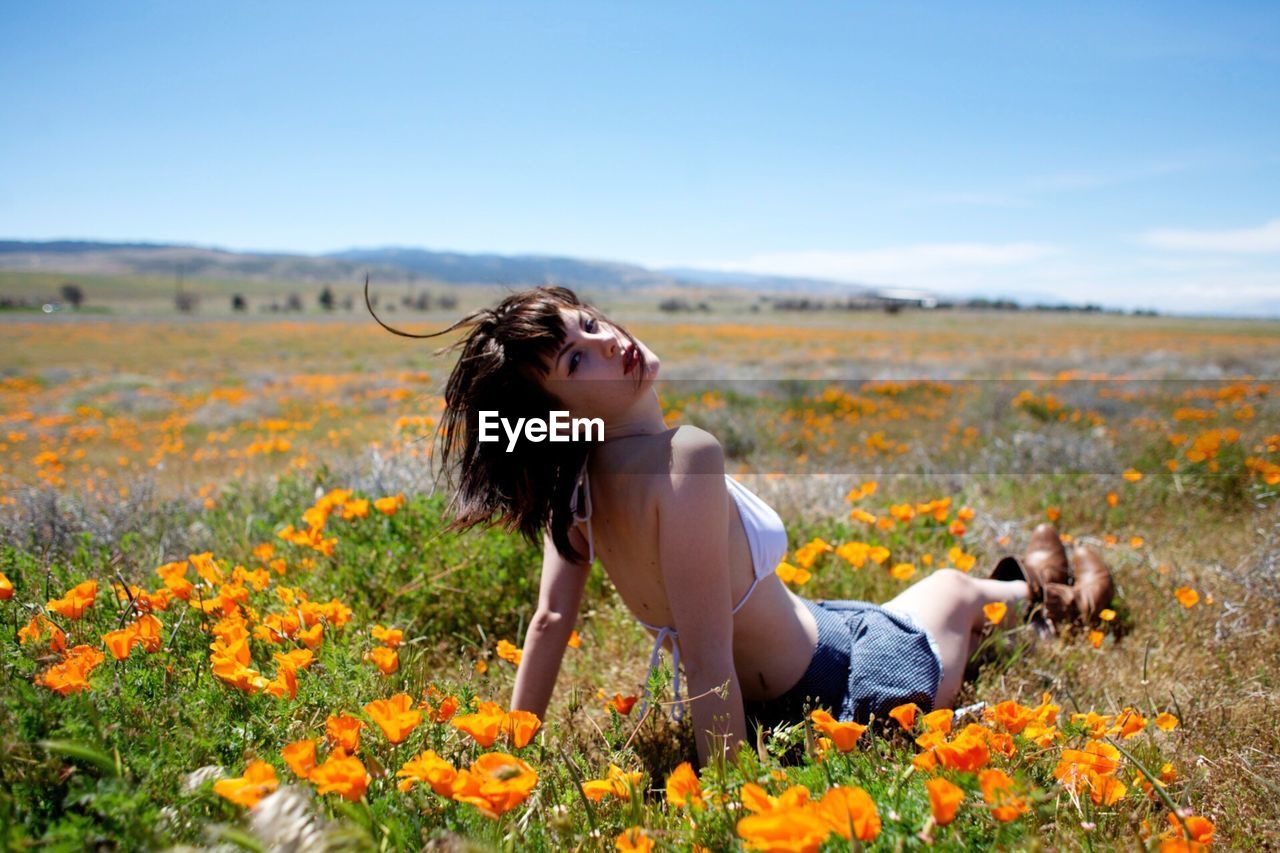 WOMAN STANDING ON FIELD