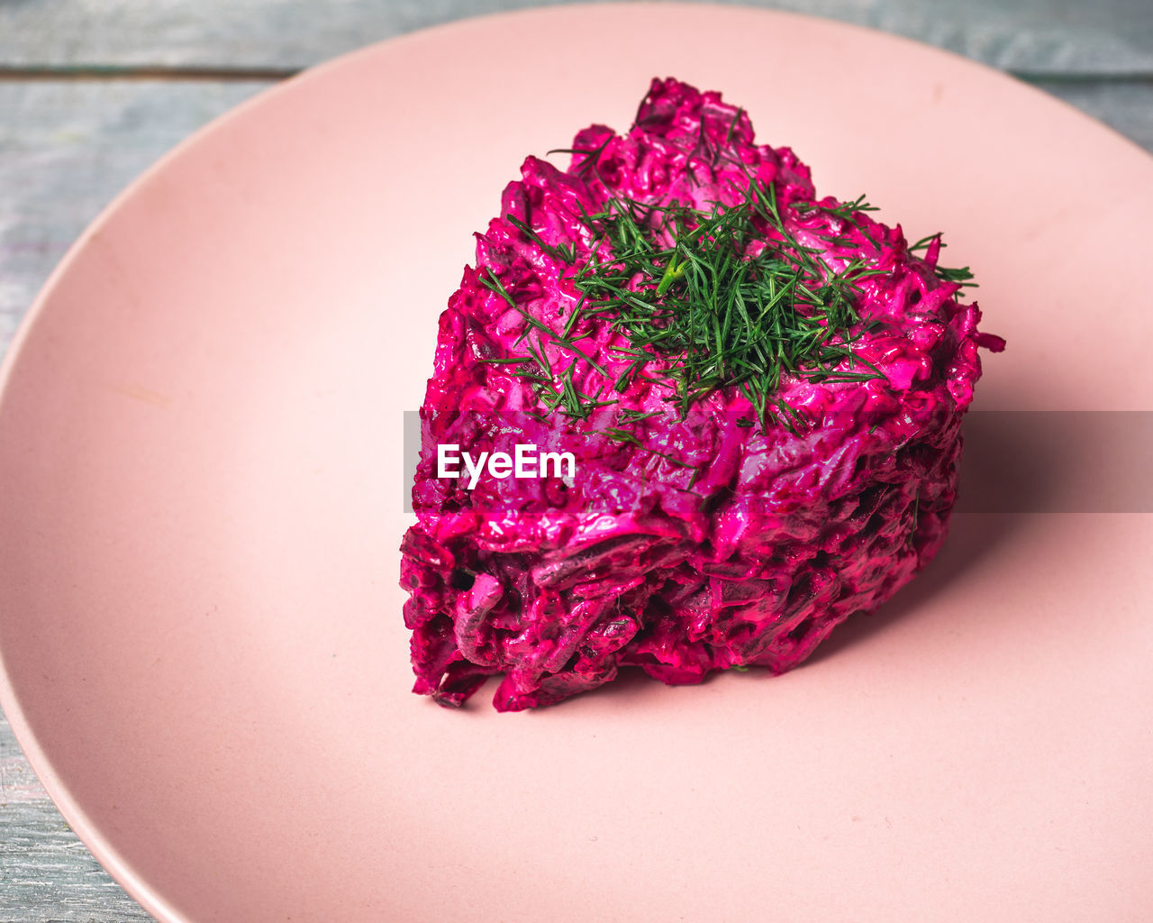 Beetroot salad with feta cheese and dill on a pink plate, breakfast for valentine's day