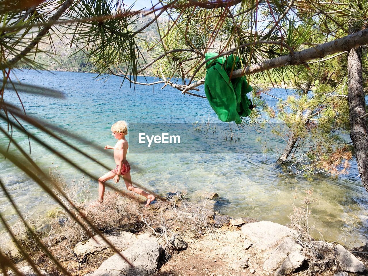 Boy wading into water