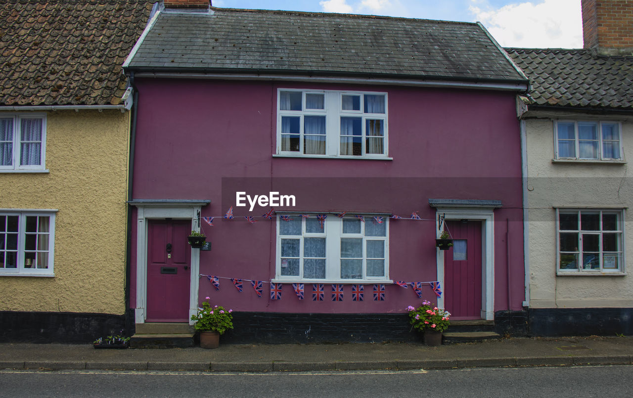 A colourful house with union flag bunting to celebrate the queen's platinum jubilee in eye, uk