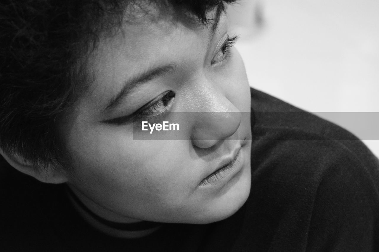 Black and white portrait of a young girl looking away