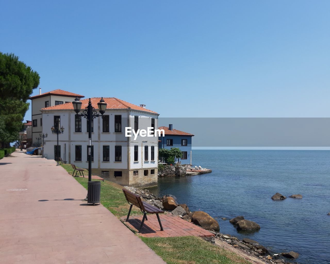 BUILDINGS BY SEA AGAINST CLEAR SKY