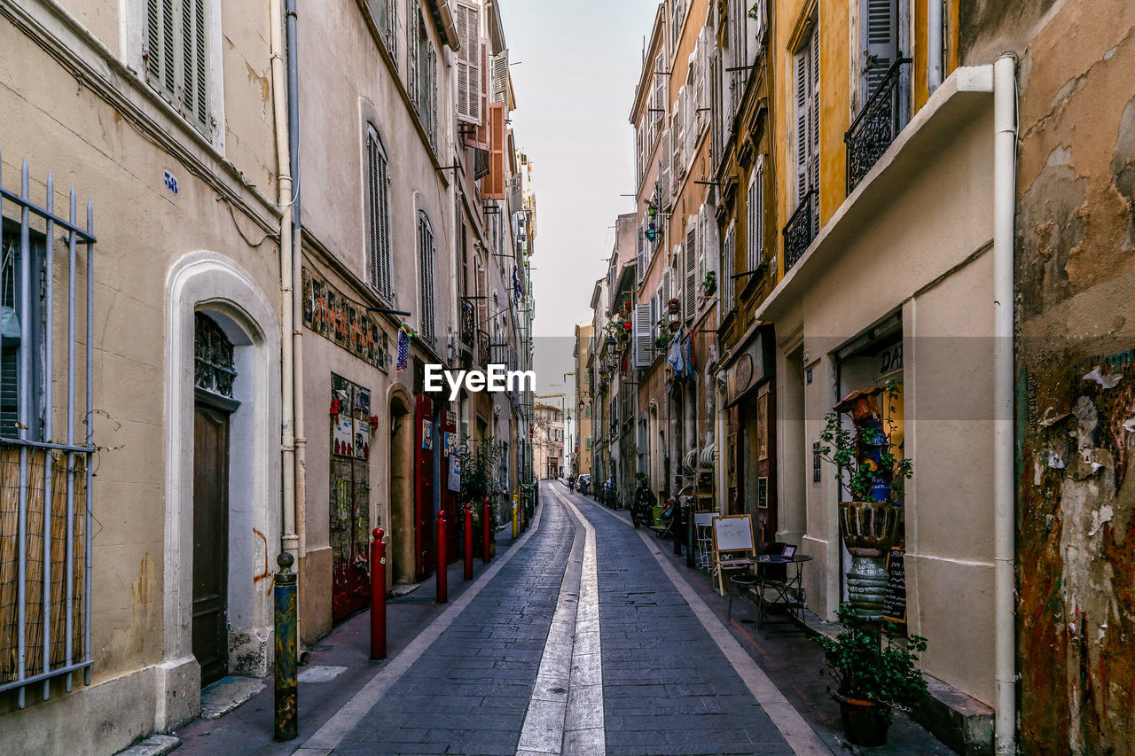 Street amidst buildings against sky