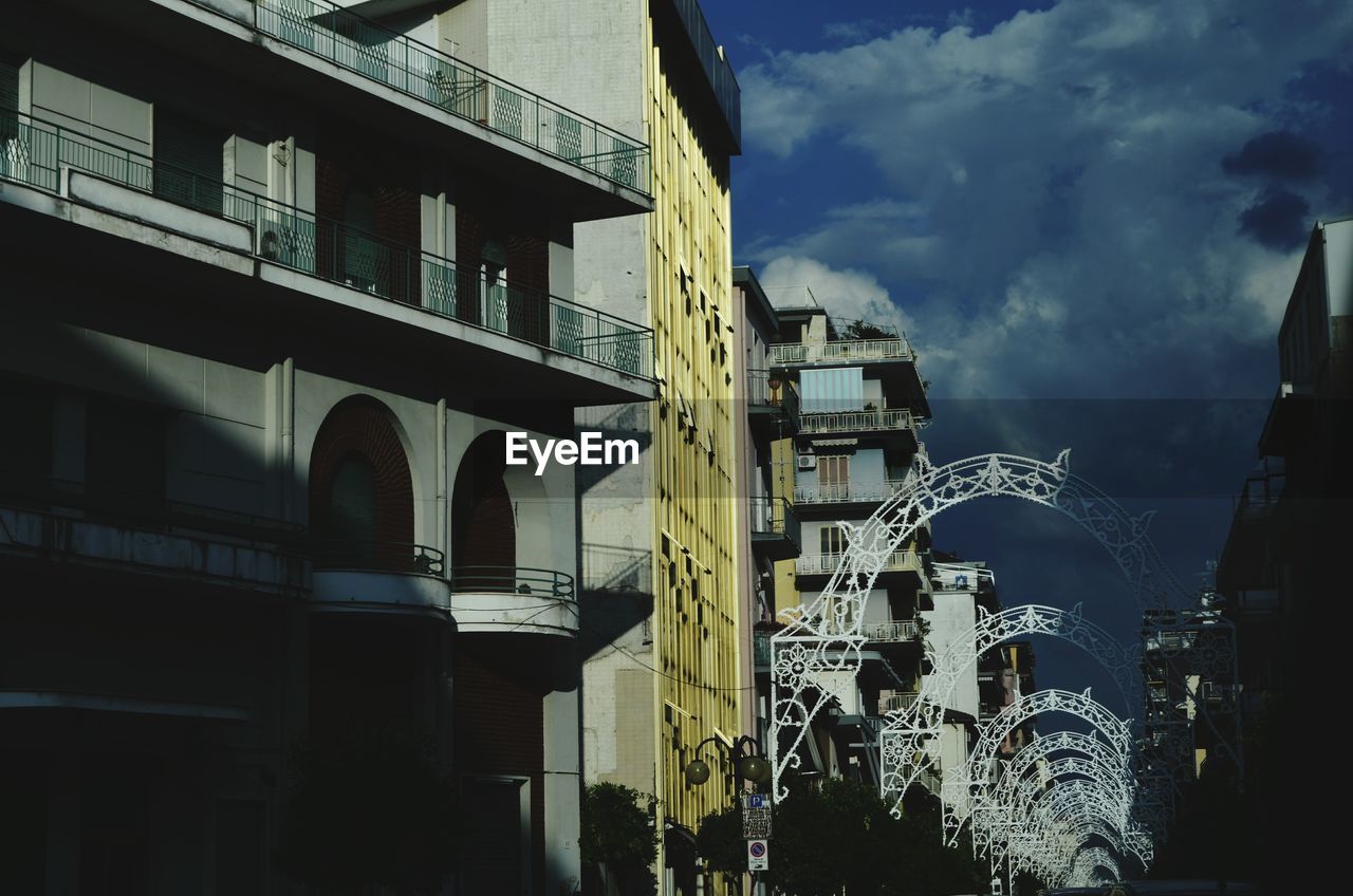 BUILDINGS AGAINST CLOUDY SKY