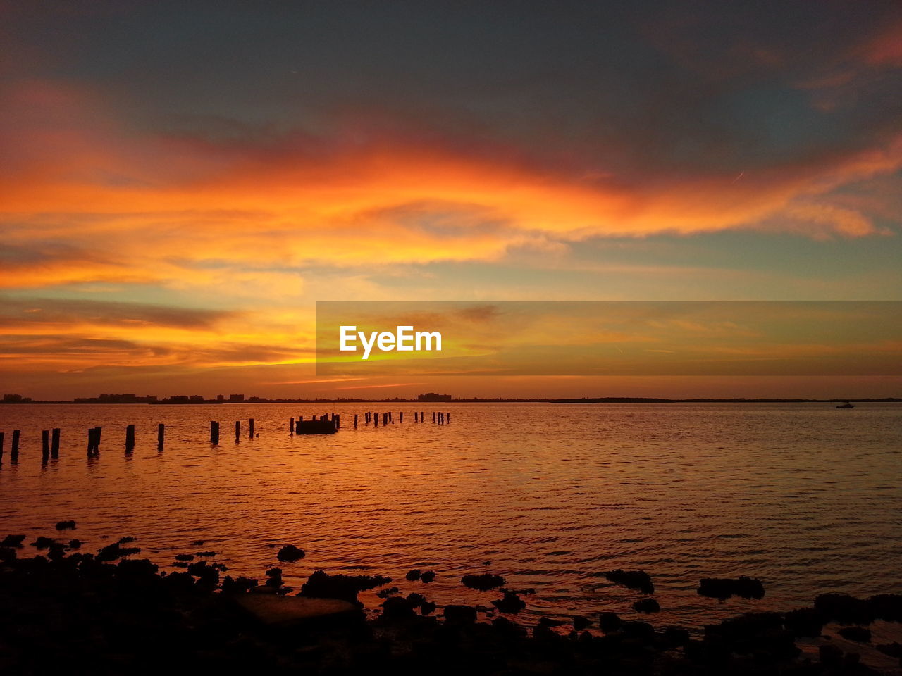 Cloudy sky above lake at sunset