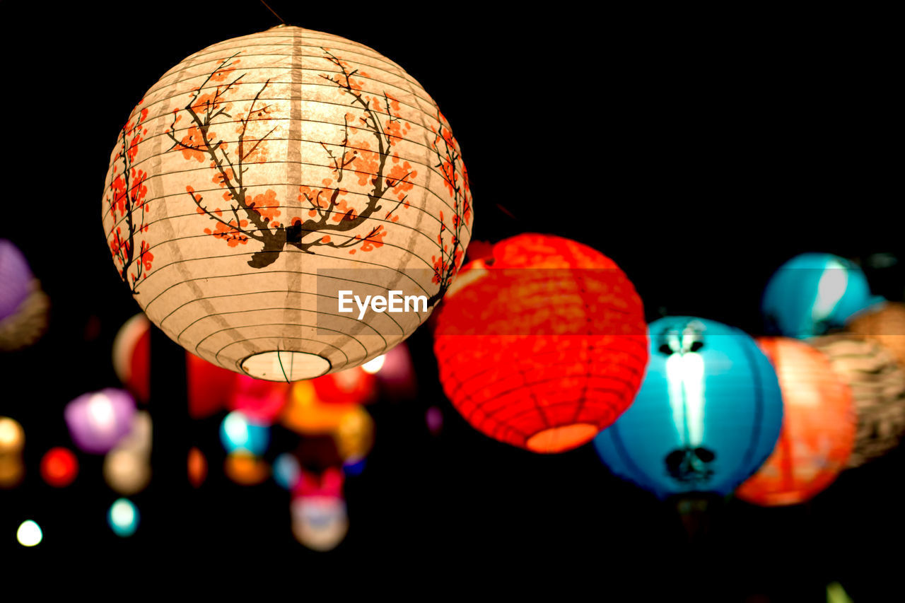 Low angle view of colorful lanterns hanging against the sky