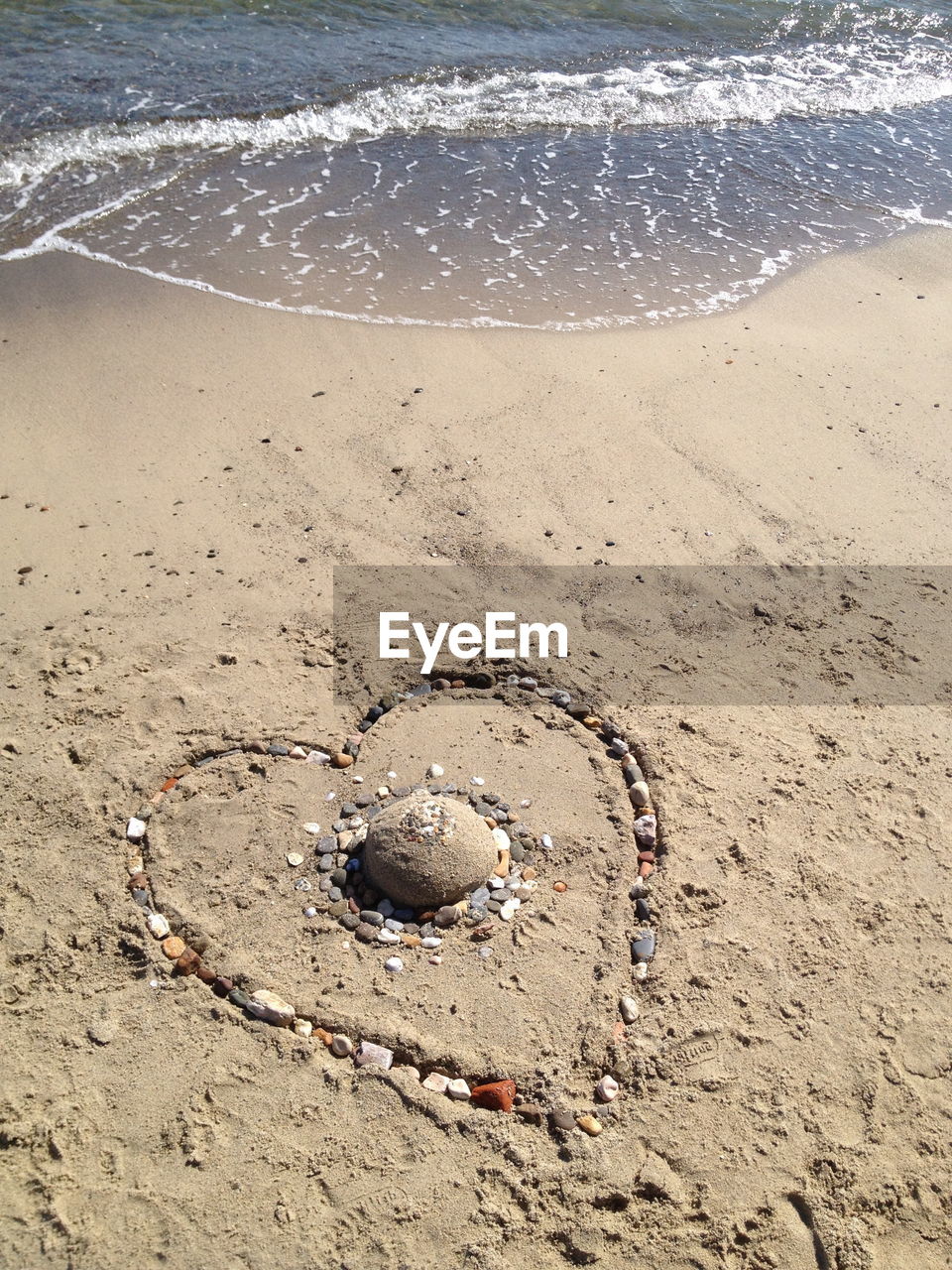 Heart shape drawing on sandy beach