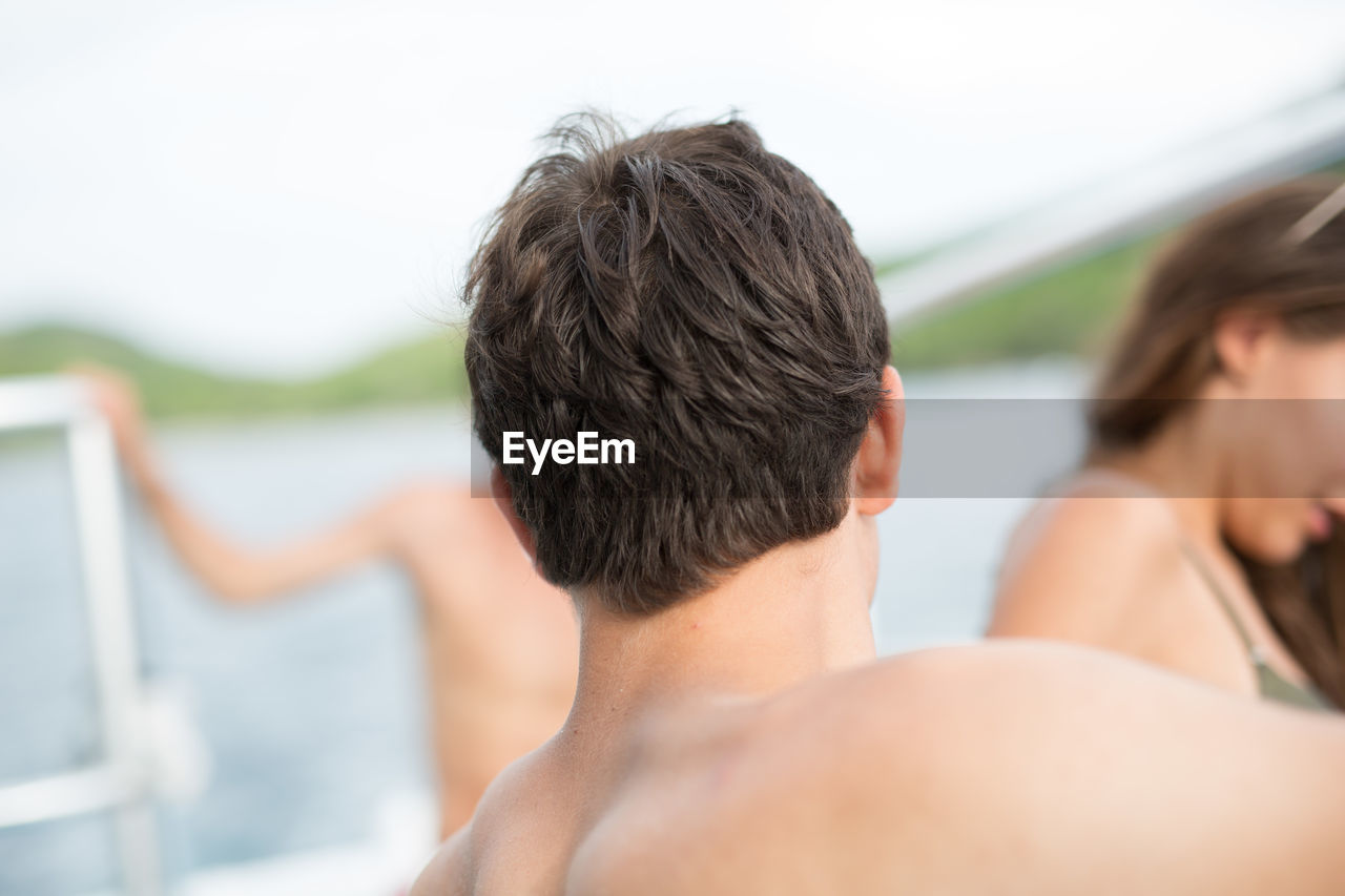 People with lake in the background