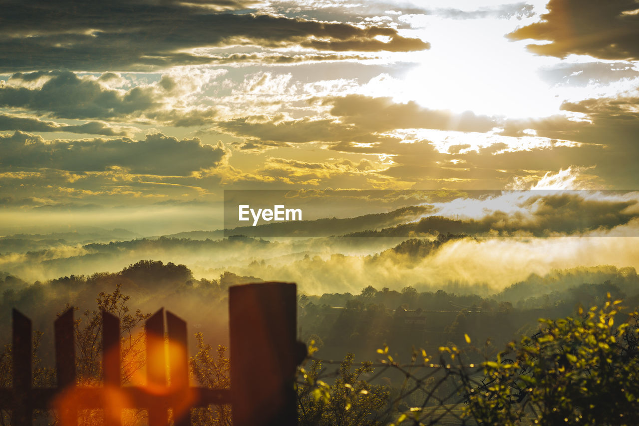 Scenic view of buildings against sky during sunset