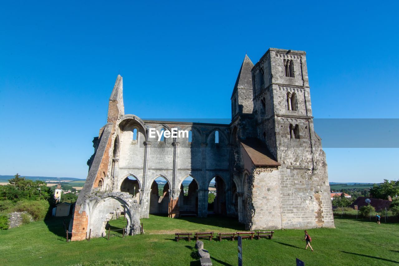 Old ruins of building against clear blue sky