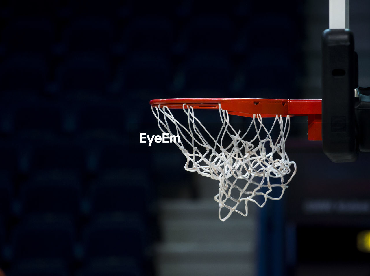 Close-up of basketball hoop hanging on sports court