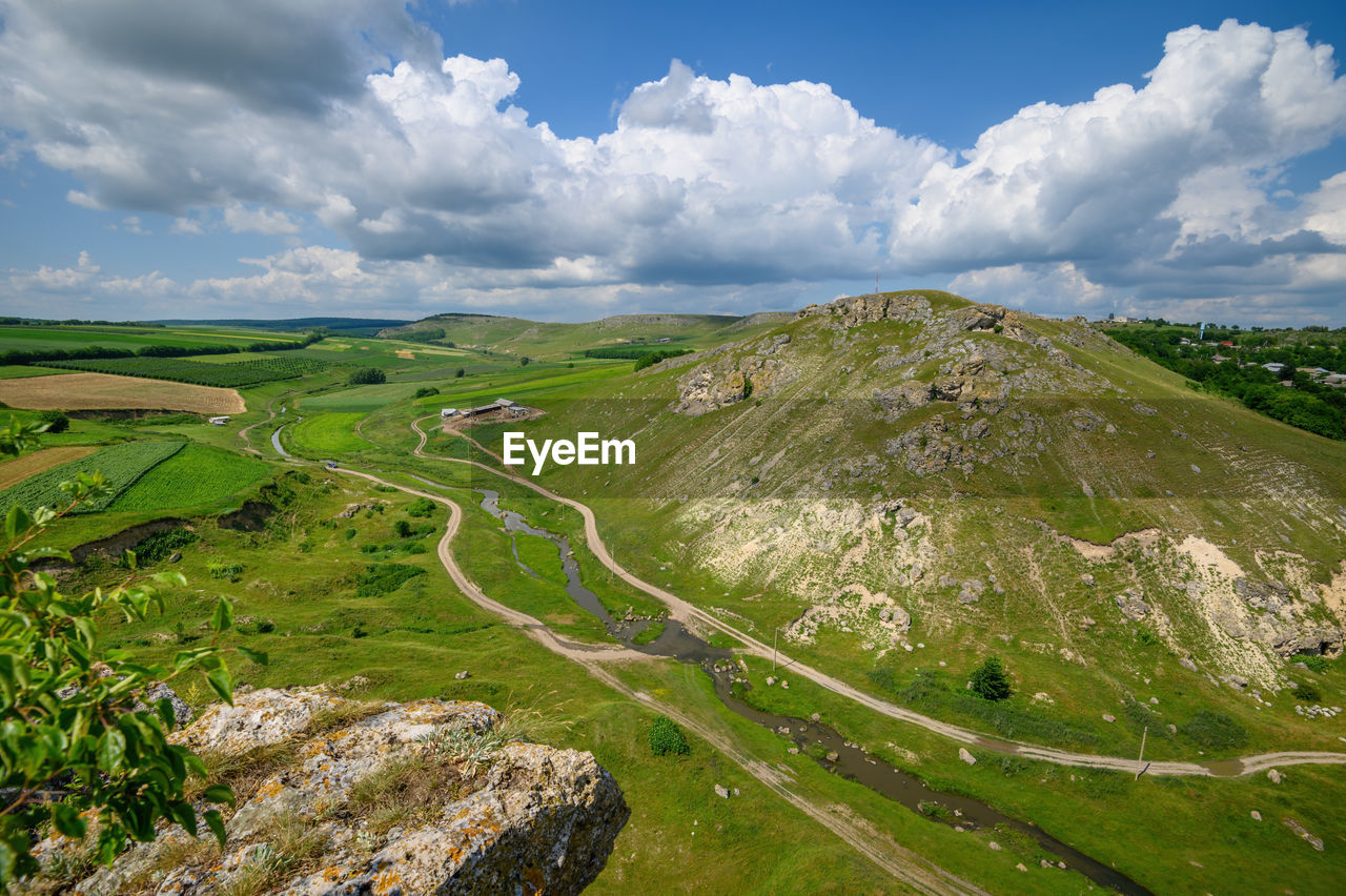 PANORAMIC SHOT OF ROAD AMIDST LAND AGAINST SKY