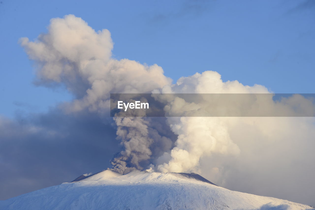 Low angle view of snowcapped mountains against sky