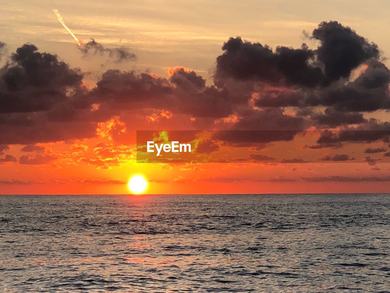 SCENIC VIEW OF SEA AGAINST ORANGE SKY DURING SUNSET