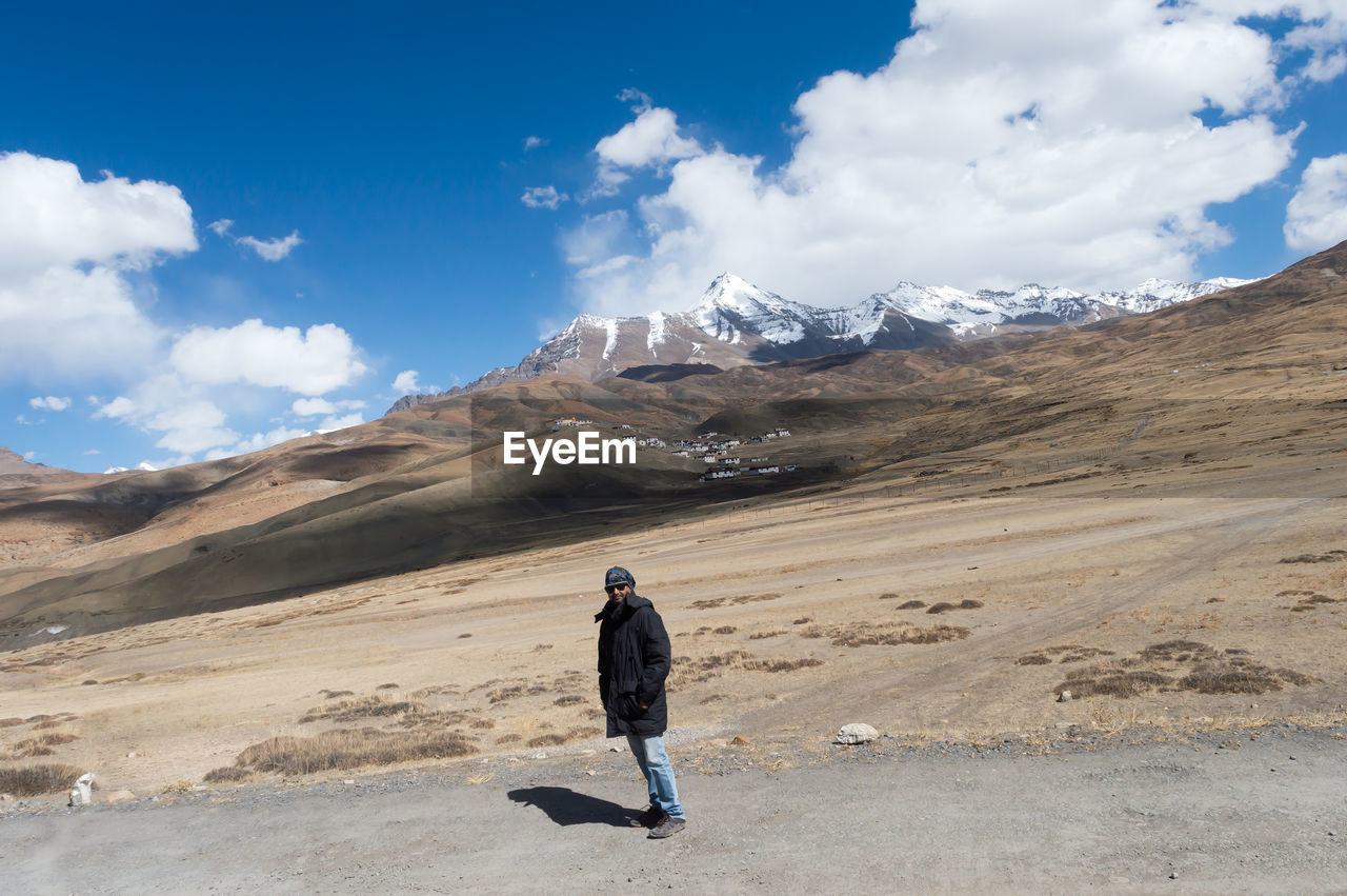 MAN ON SNOWCAPPED MOUNTAINS AGAINST SKY