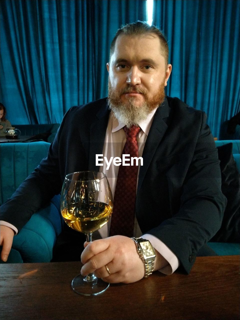 Portrait of businessman holding wineglass